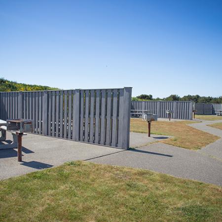 Picnic tables with a privacy fence at Westport Lighthouse State Park. 