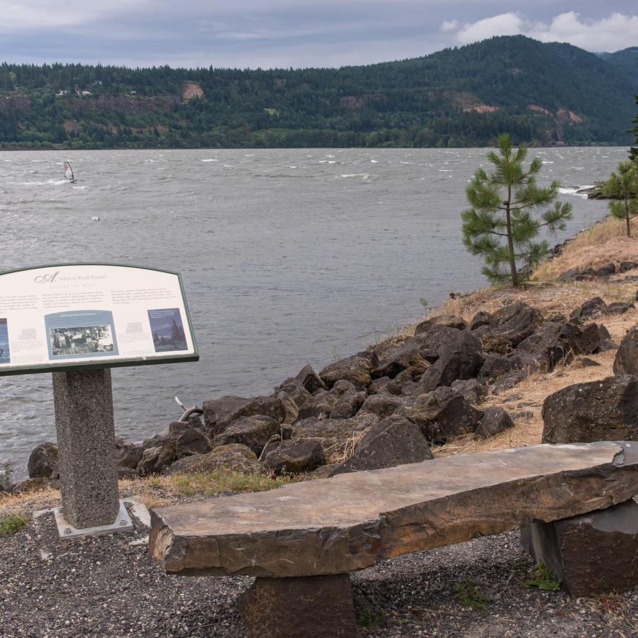 Rock bench and interpretive panel overlooking the windy Columbia River.