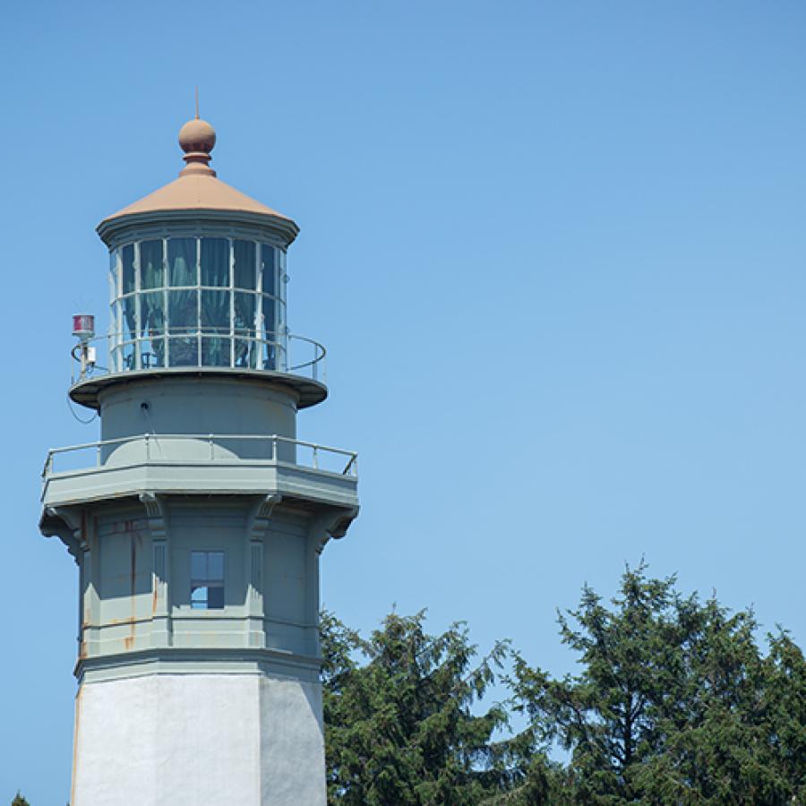 The top view of Westport Lighthouse on a clear blue sky day.