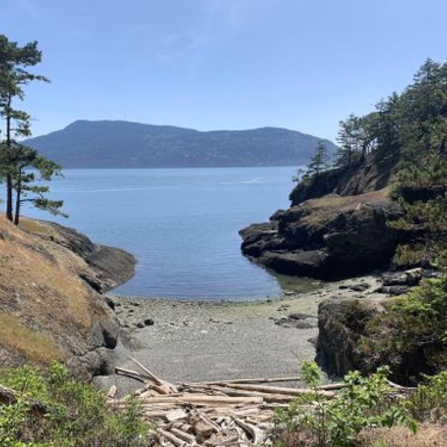 view of coast from island trail with beach and rocks around