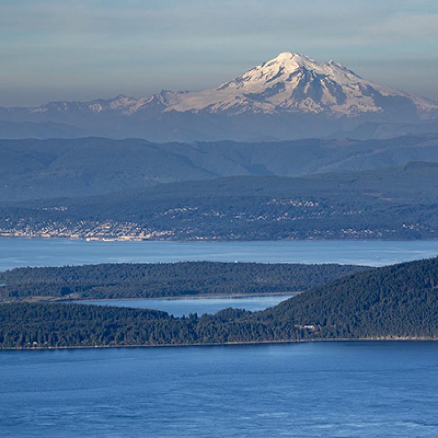 expansive view of the horizon with lake and spectacular mountain range