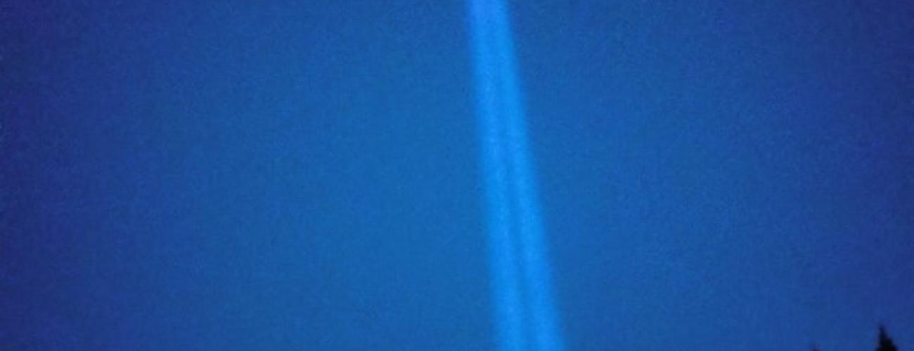 Searchlight beam lighting up the sky