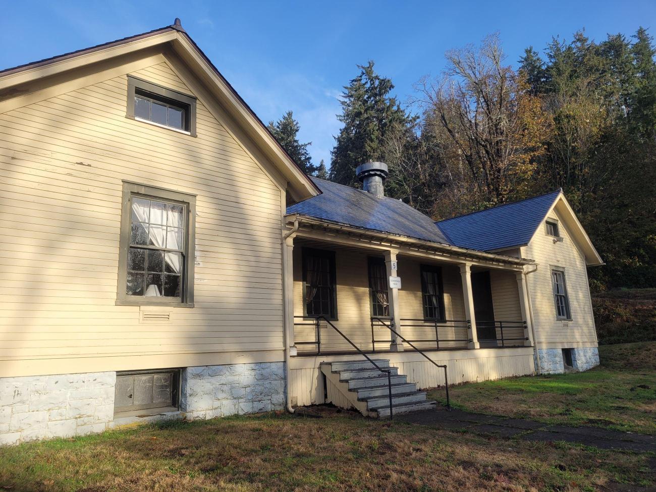 A historic home sits in sun and shade.