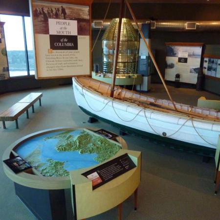 A boat display, and an interactive earth display inside Cape Disappointment's Interpretive Center.
