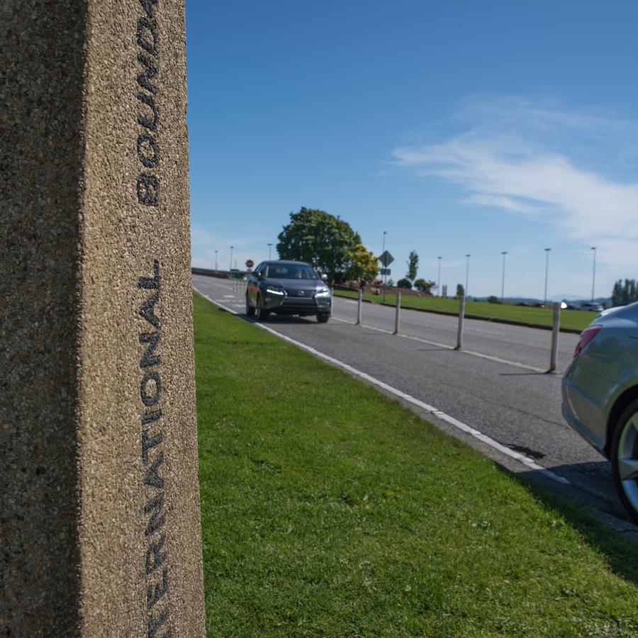 Stone sign showing Canada's, international boundary and United States side