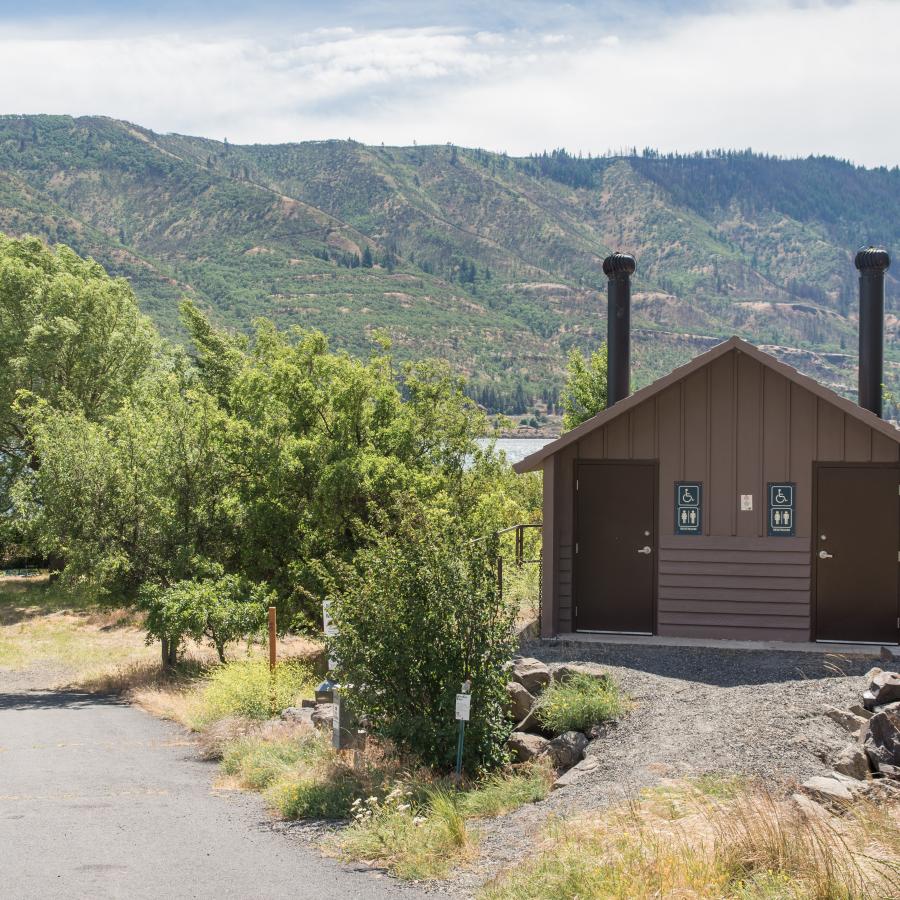 park facilities building with paved walkway and shrubs