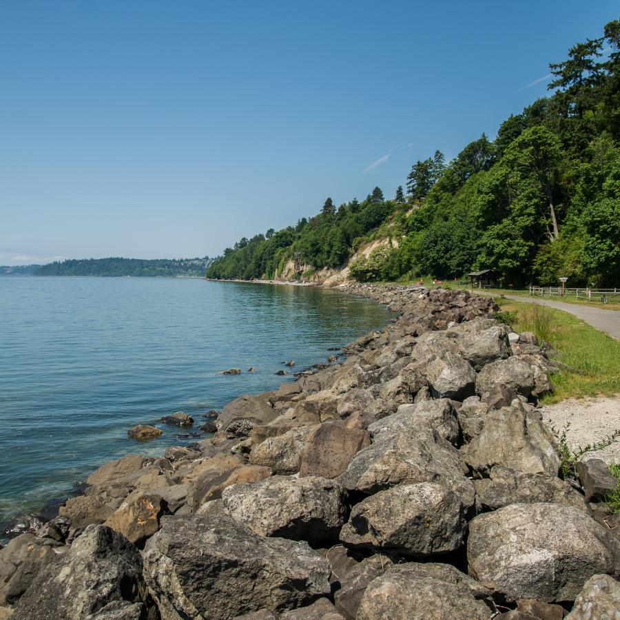 A view of a paved trail along the water at Saltwater State Park