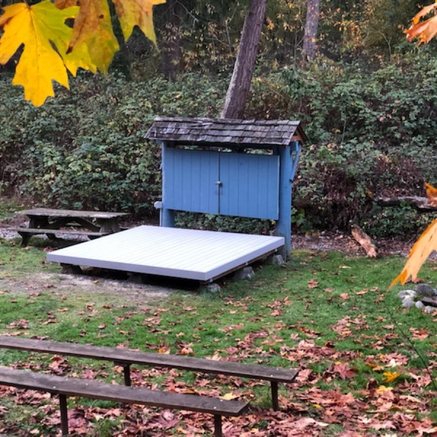 Amphitheater with seating and fall leaves in the campground of Dash Point State Park.