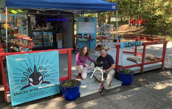 Campers and dog at park store
